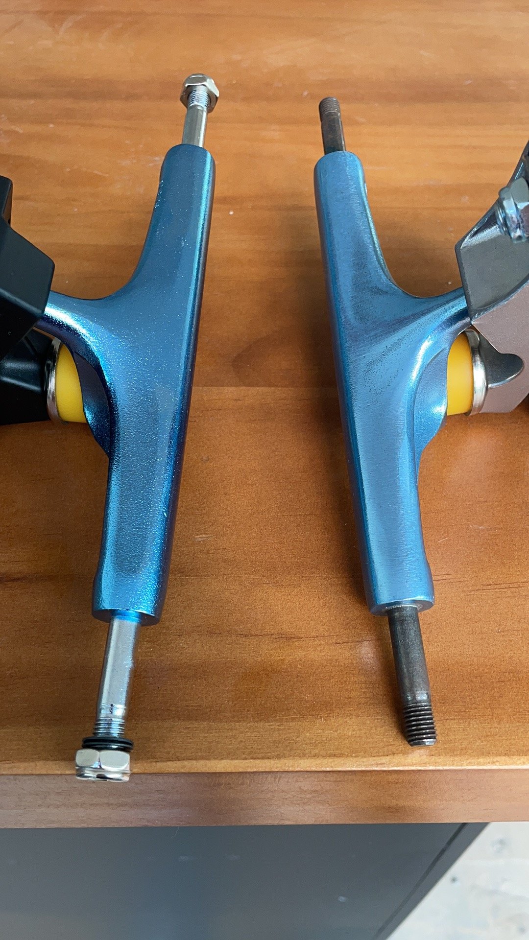 metallic blue skateboard trucks