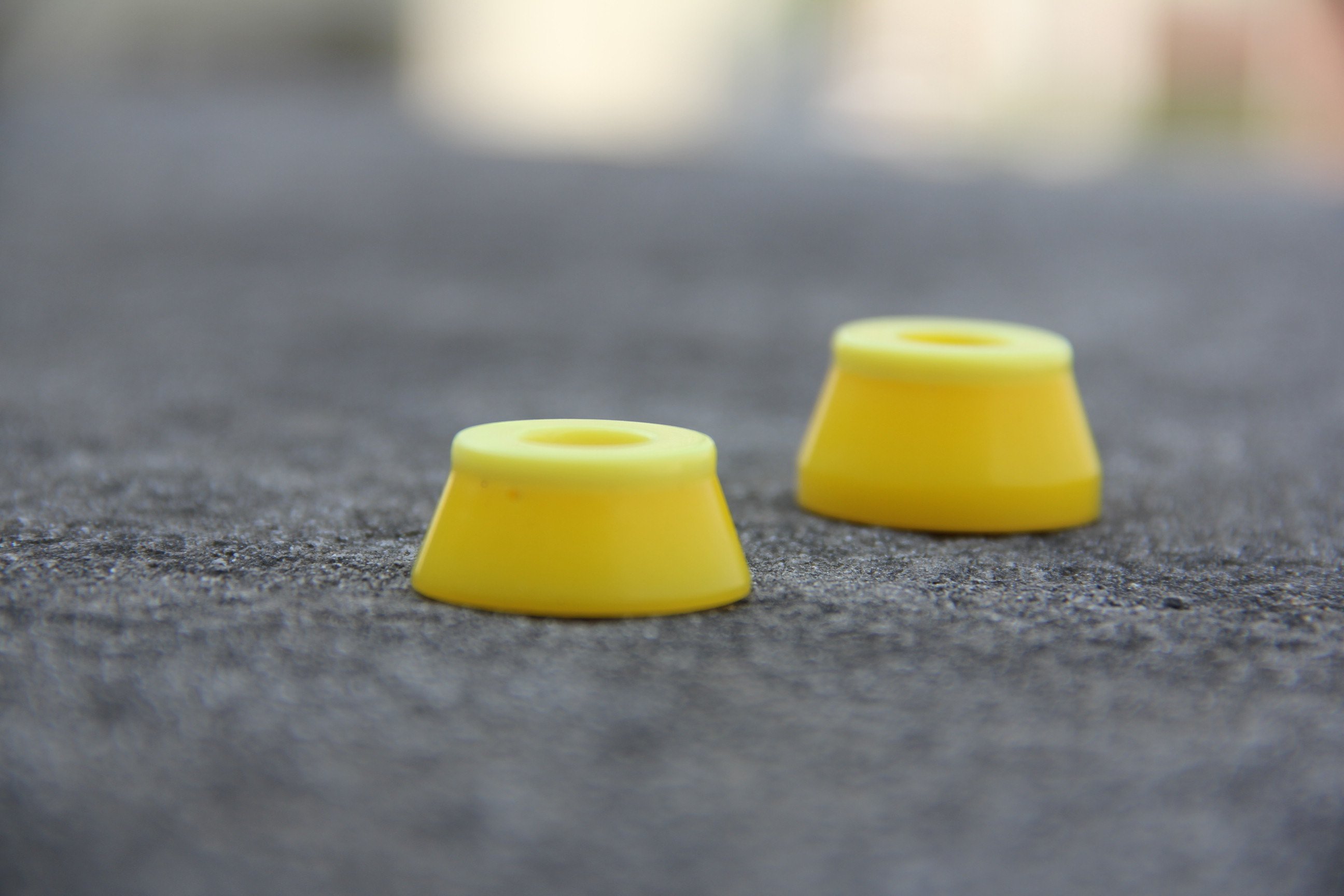 A yellow cap bushing custom made at 2HEX skateboard bushing factory
