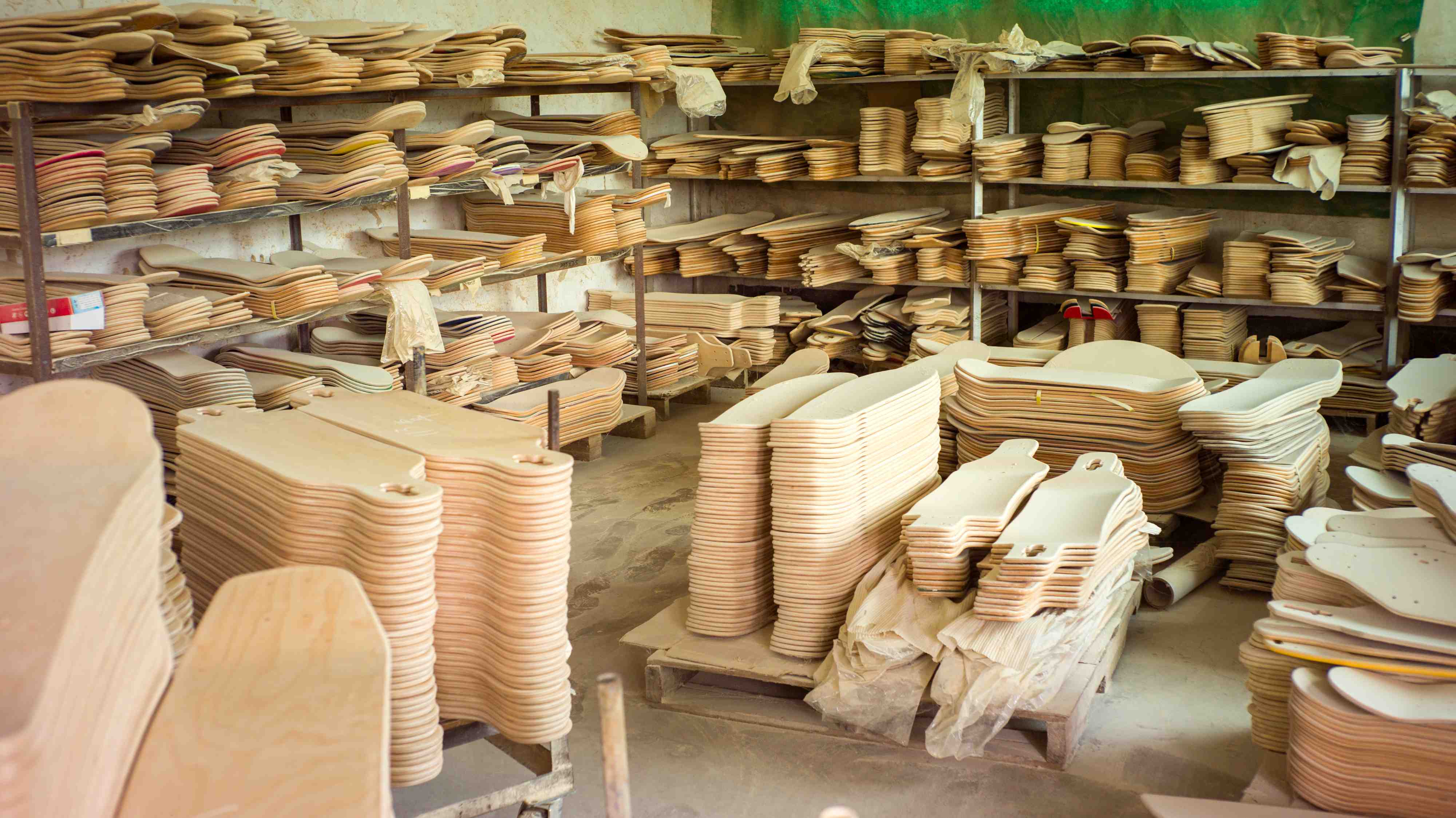 factory warehouse full of skateboard decks ready to be printed