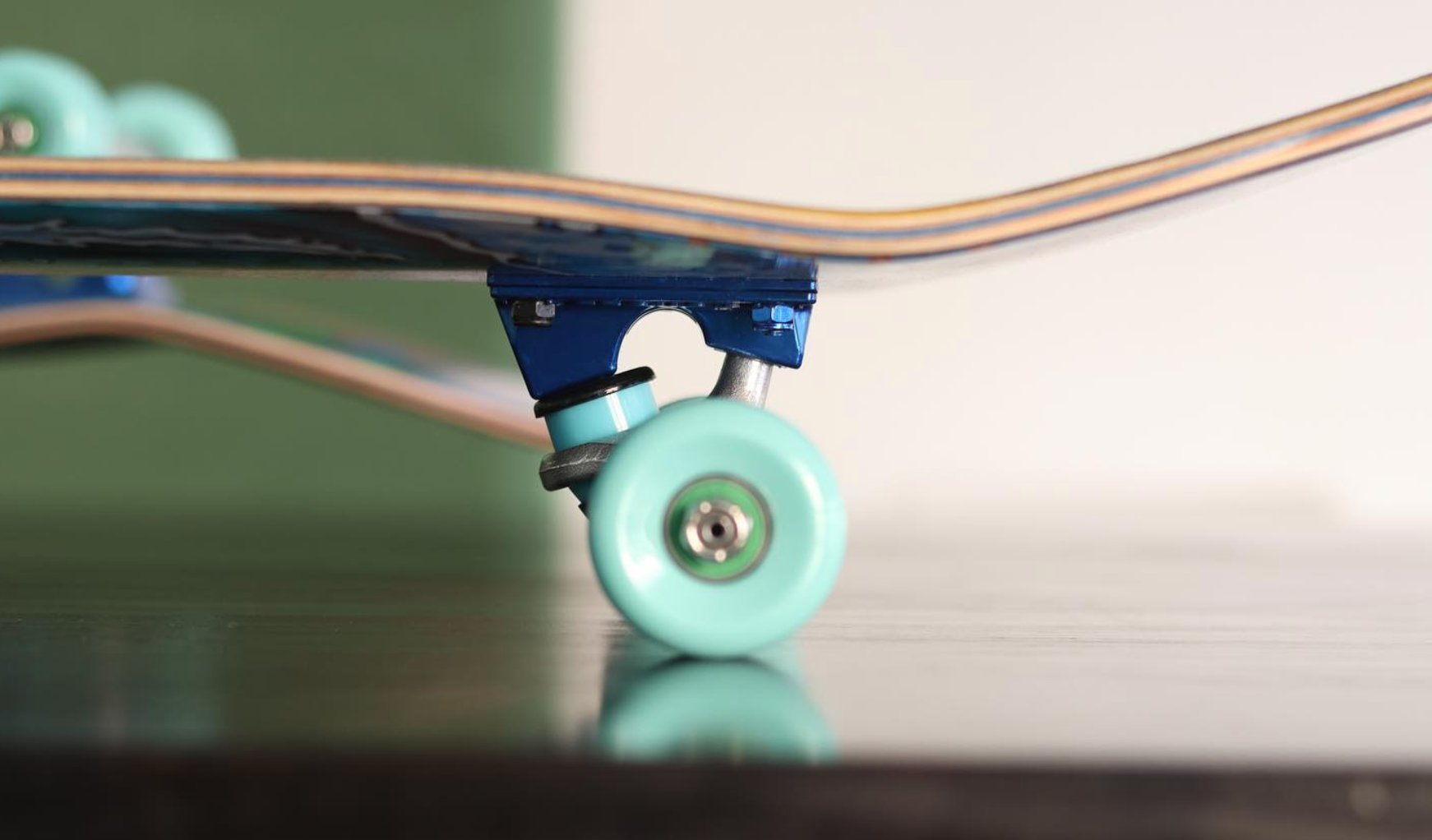 green skateboard wheel on complete skateboard