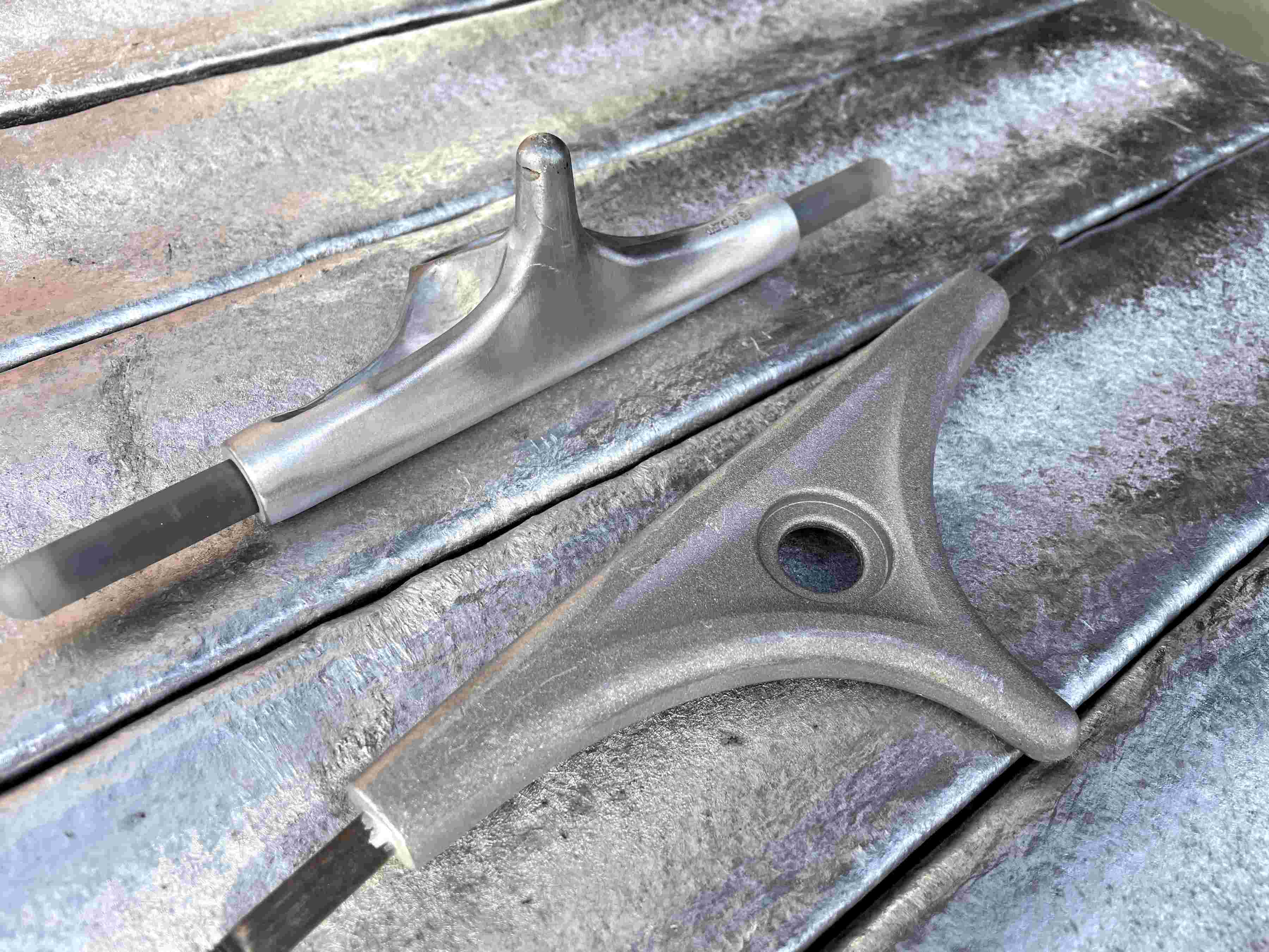 longboard truck on aluminium background inside the 2hex skateboard truck factory