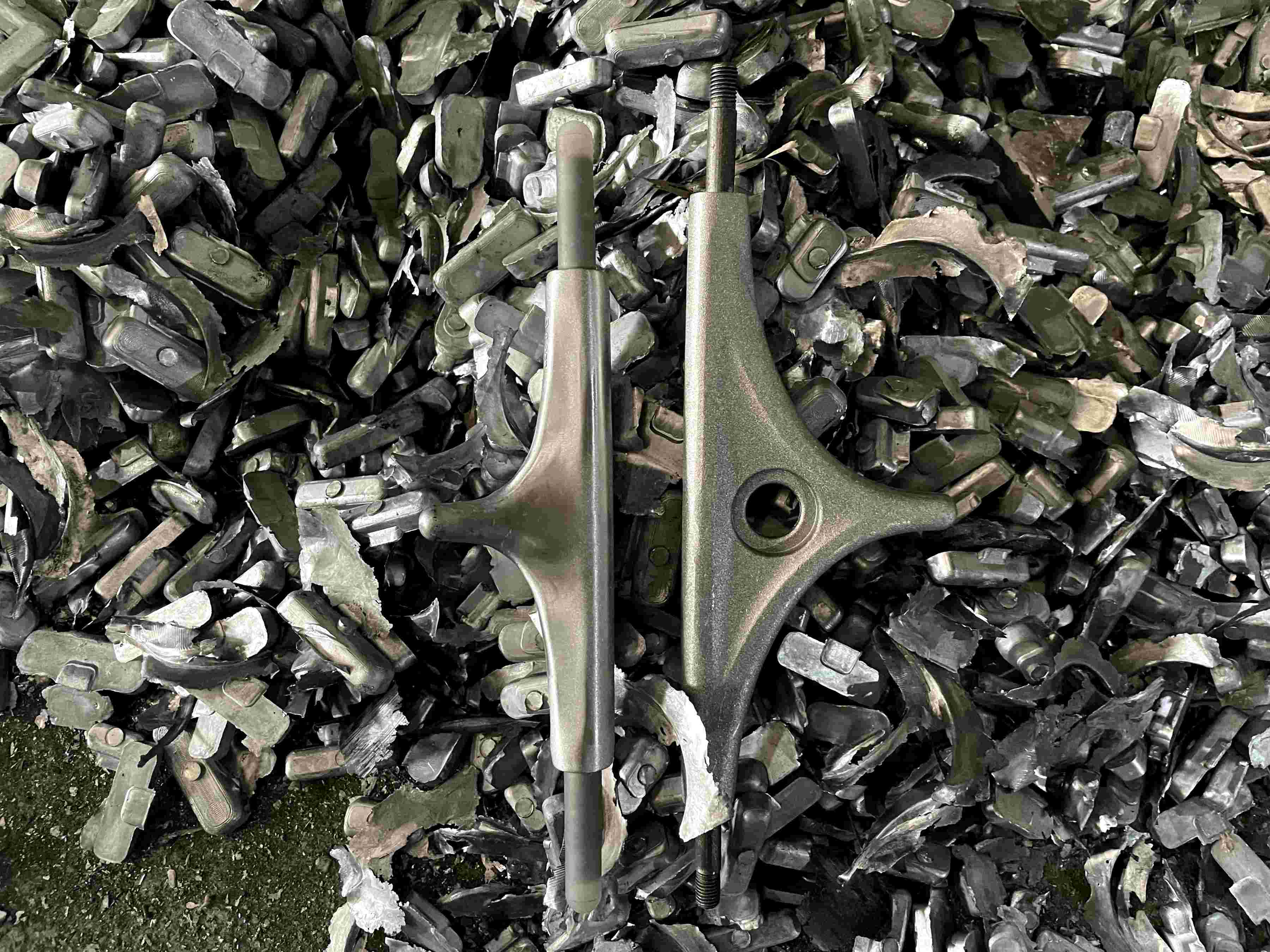 longboard trucks displayed on scrap metal