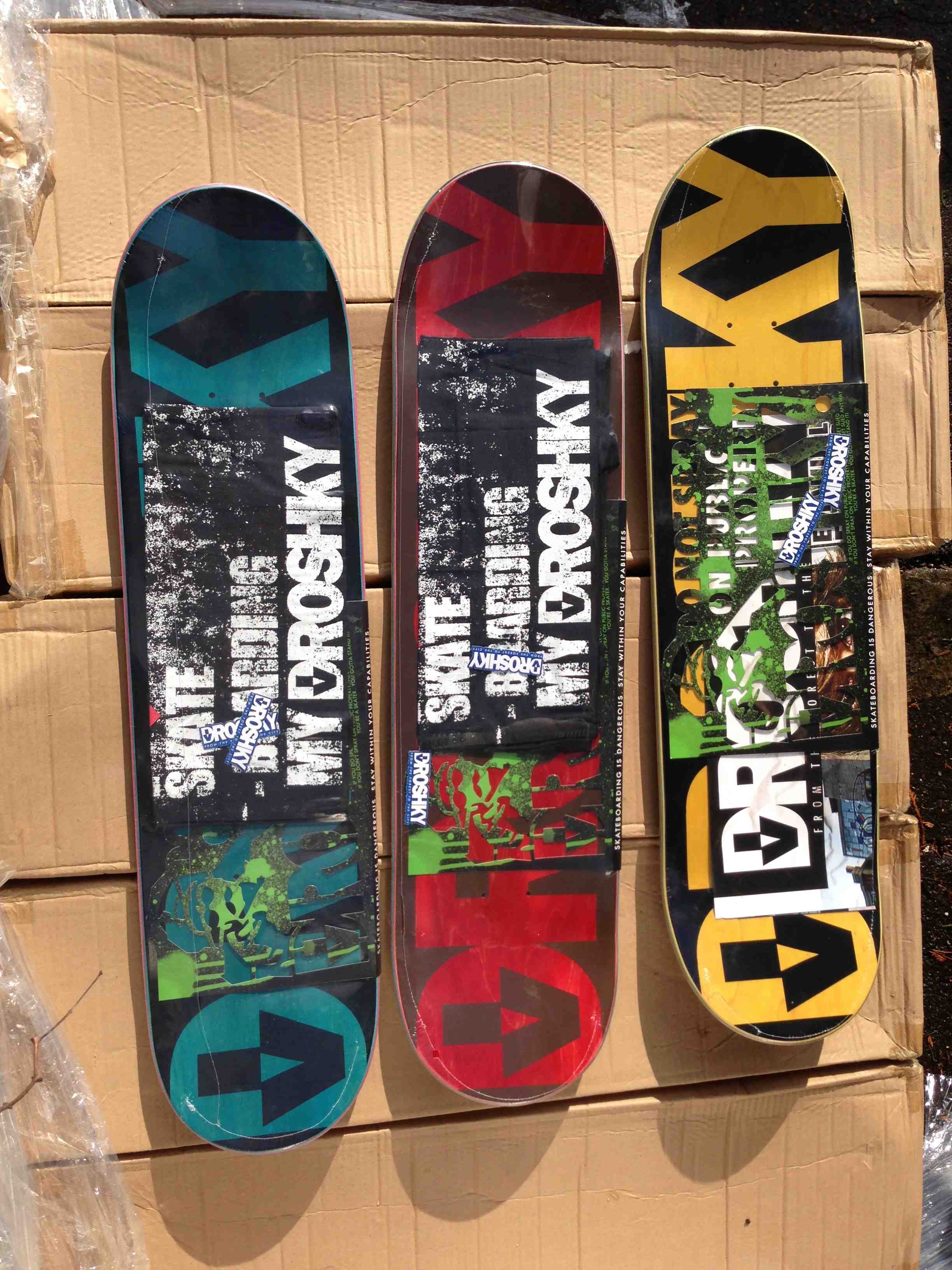 droshky decks with some cool cardboard wraps and stencils under the shrink wrap