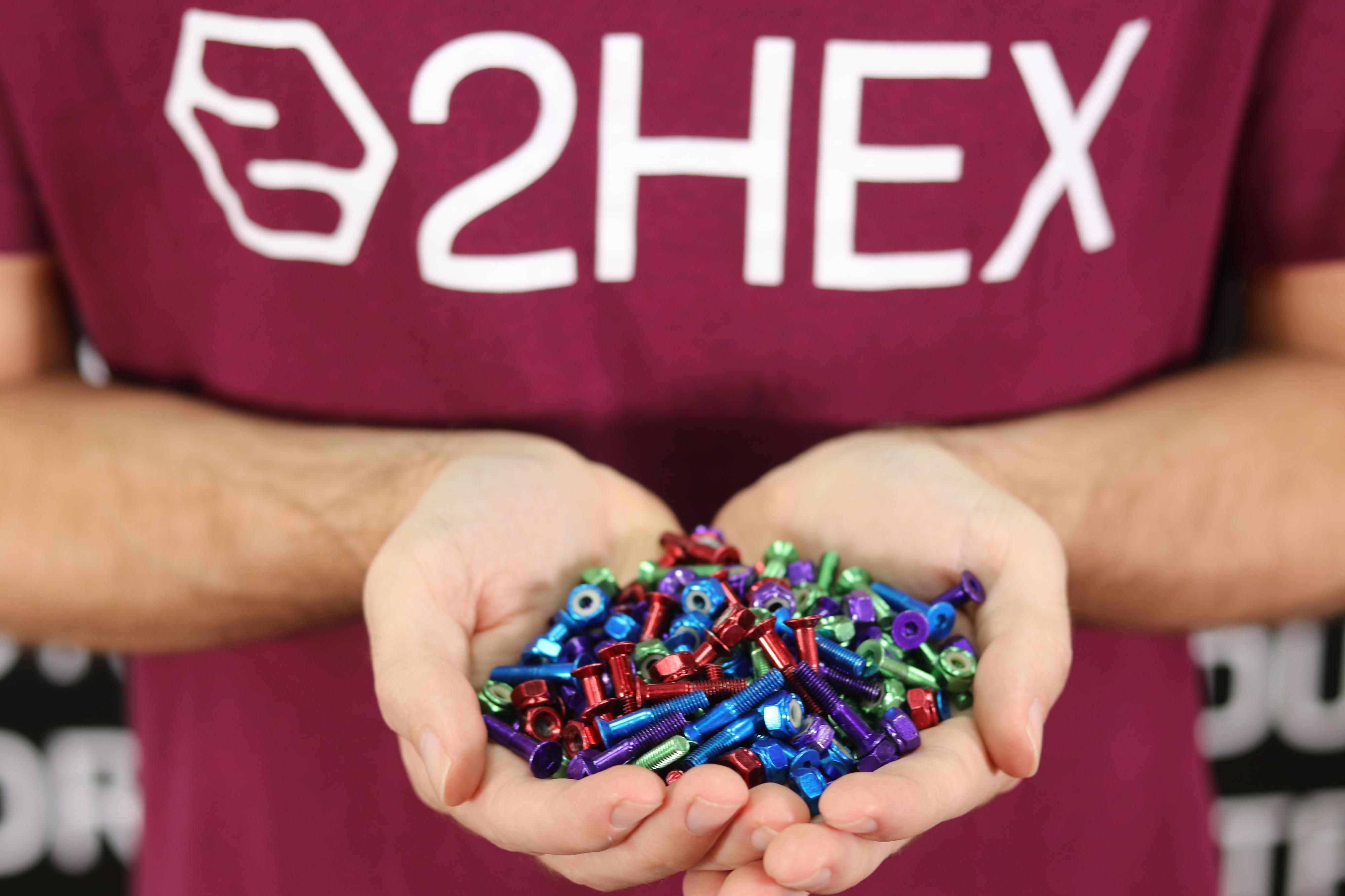 handful of colorful skateboard hardware